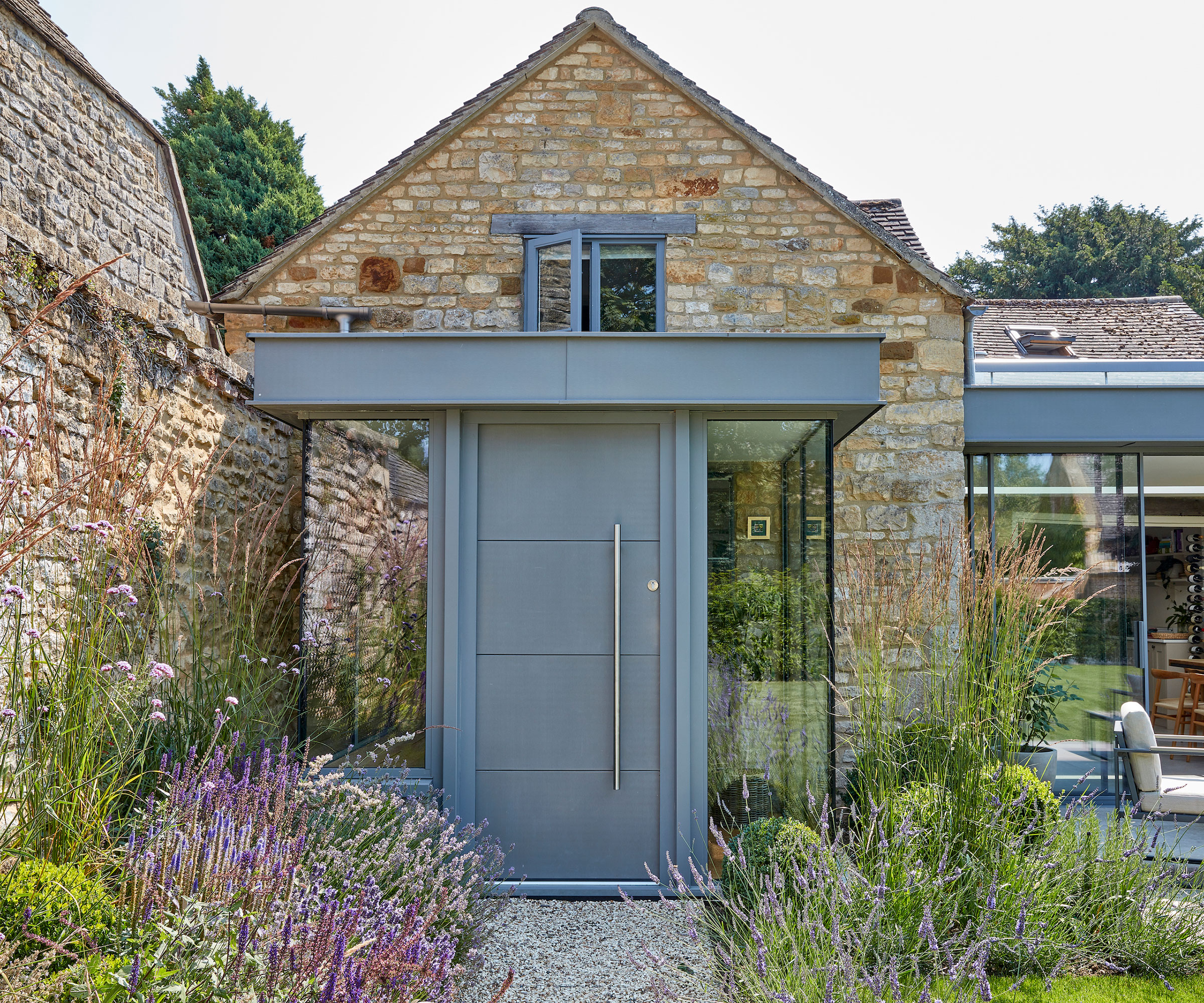 stone house with modern flat roof porch