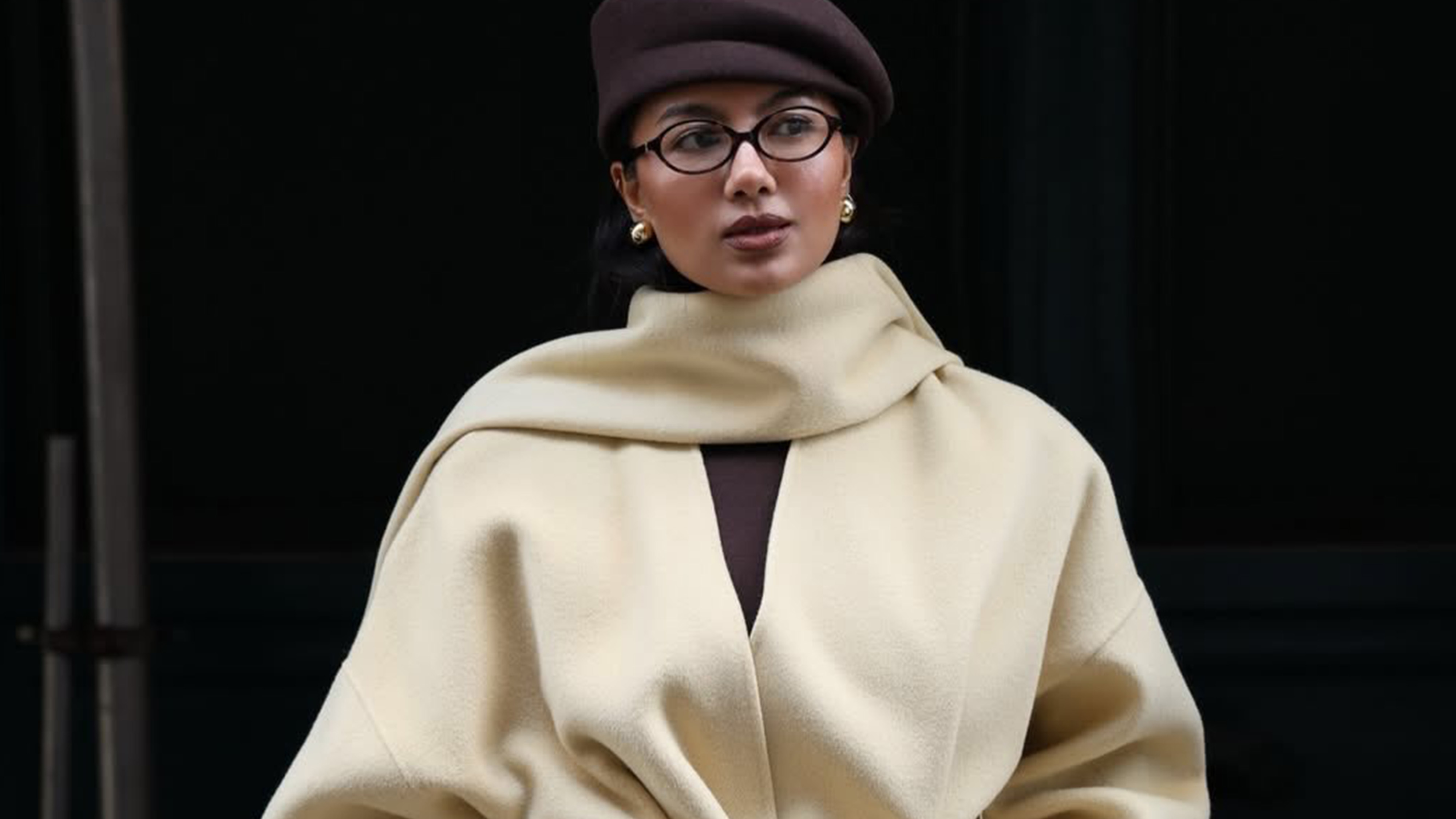 mayisha wearing a handbag and coat