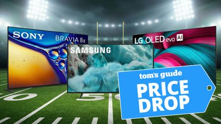 Three over-sized TVs show on a football field