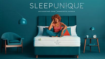 Woman sat on bed underneath Sleepunique logo