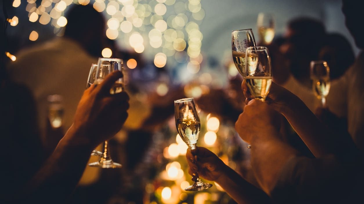 People at a party toasting with champagne glasses.