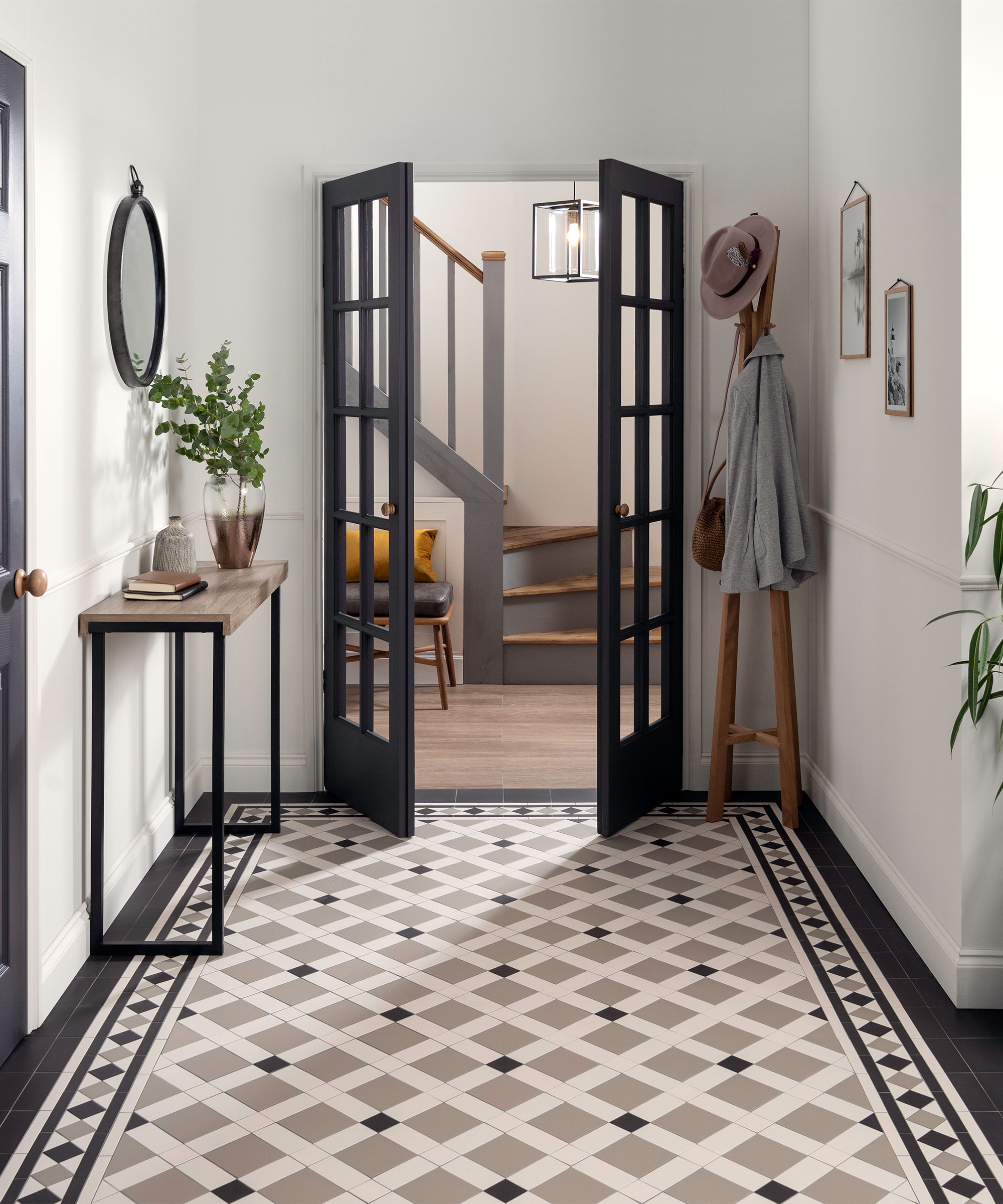 New heritage tile trends shown in a white hallway with black accents.