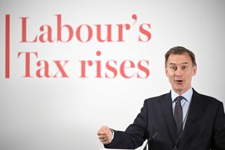 Jeremy Hunt presents the 'Labour's Tax Rises' dossier to the press on 17 May 2024 (Photo by Leon Neal/Getty Images)