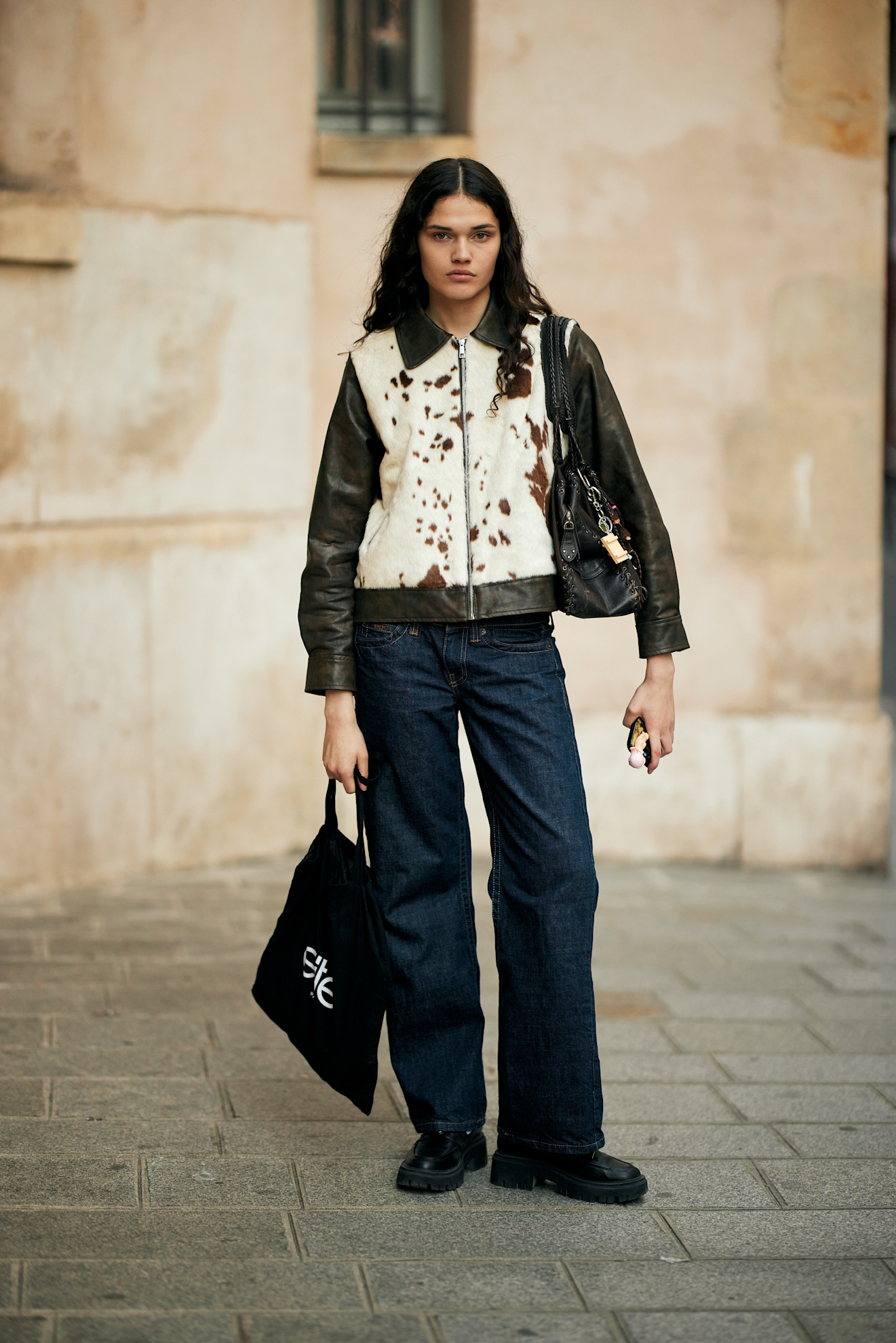 woman wearing cow print jacket, jeans, and boots