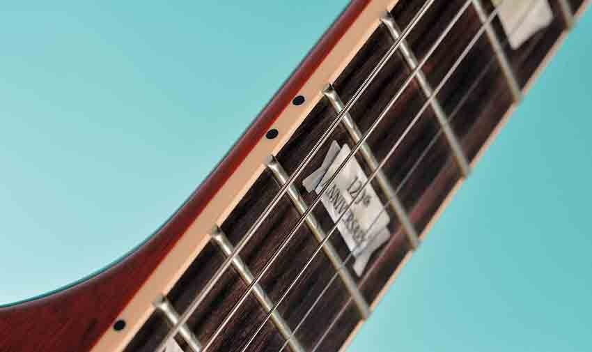 There's a 12-inch-radius rosewood 'board and Gibson 120th Anniversary inlays