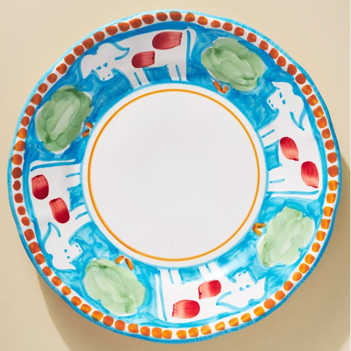 A dinner plate, hand painted with cows and trees