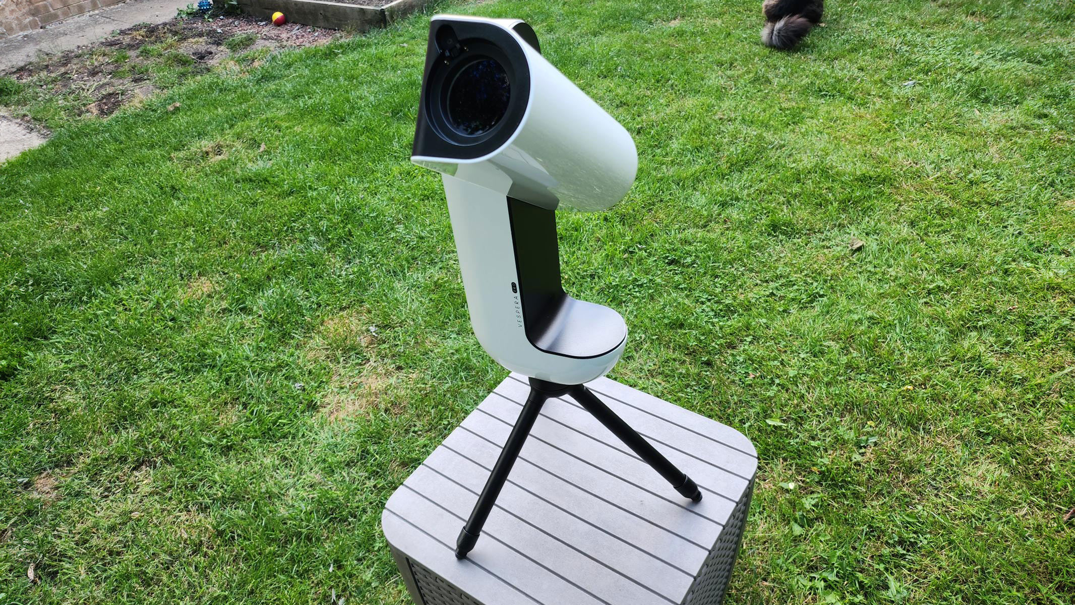 The Vaonis Vespera Pro pointed upwards with grass in the background.