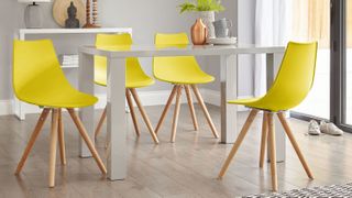 dining set with white table and bright yellow chairs by danetti