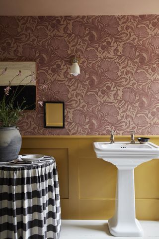 Cottage bathroom with yellow paneling and pink floral Masquerade wallpaper by Little Greene