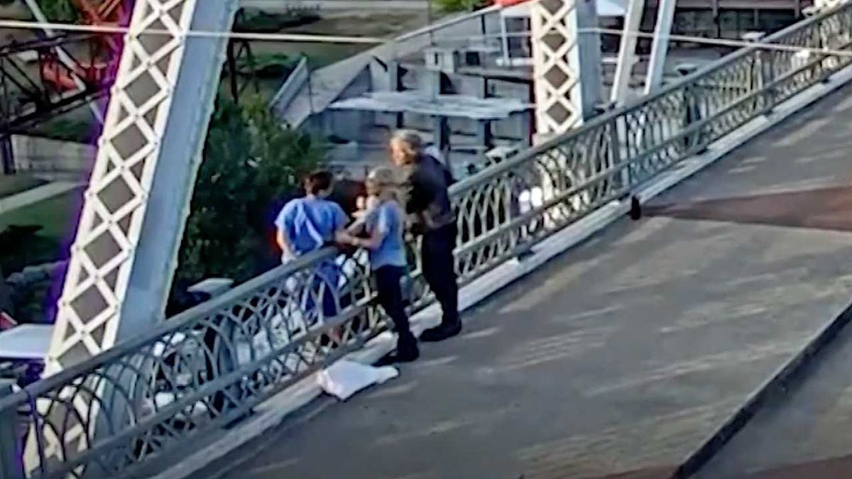 Jon Boni Jovi and a passer-by talking to a distressed citizen on on the John Seigenthaler Pedestrian Bridge