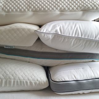 A pile of pillows of different styles