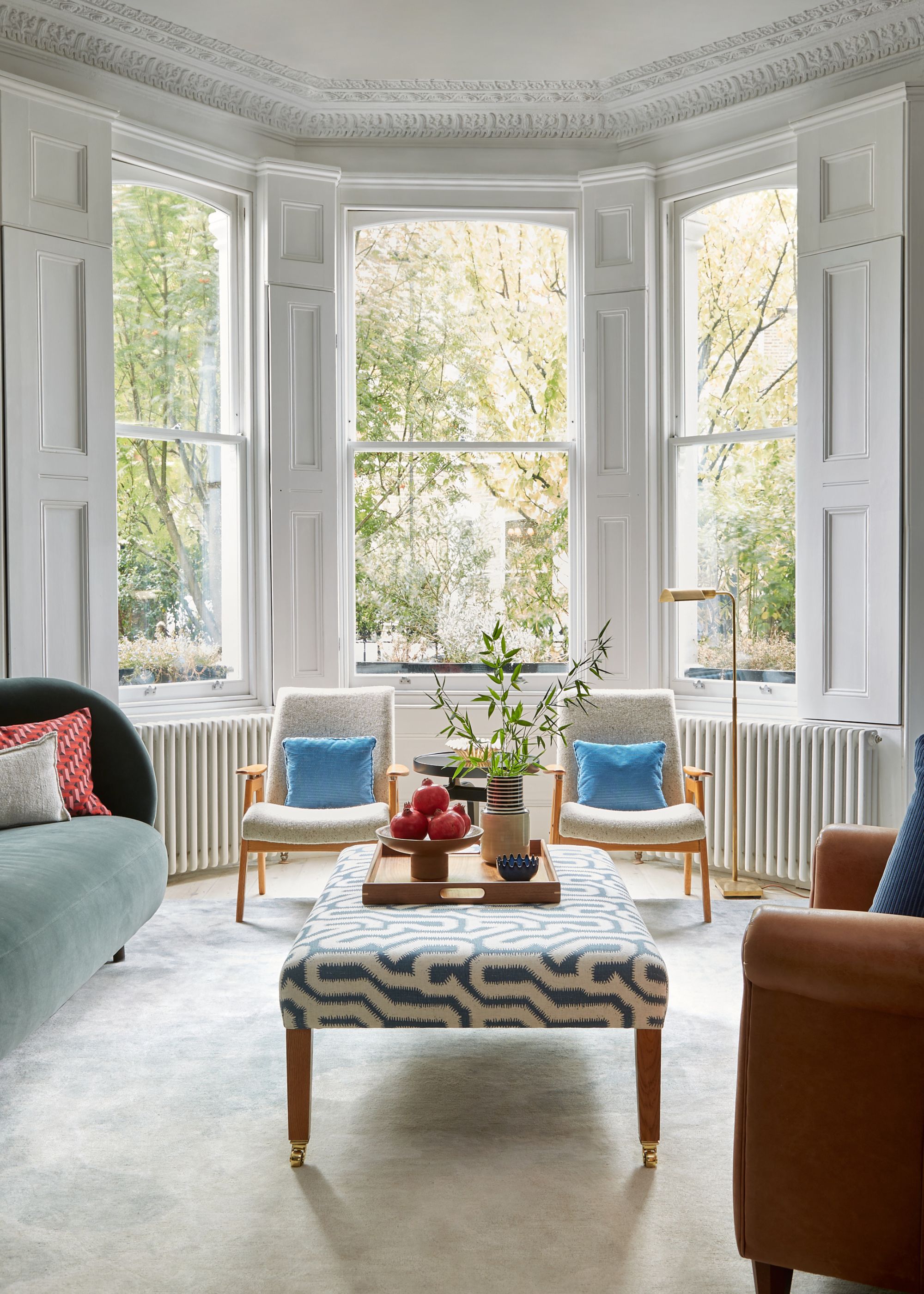 light and airy living room with traditional bay window, white walls and modern decor