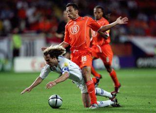 Netherlands defender John Heitinga brings down the Czech Republic's Pavel Nedved and earns a second yellow card in the teams' group game at Euro 2004.