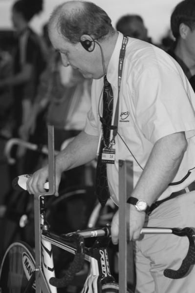 UCI judges weighing and measuring bikes before the race.