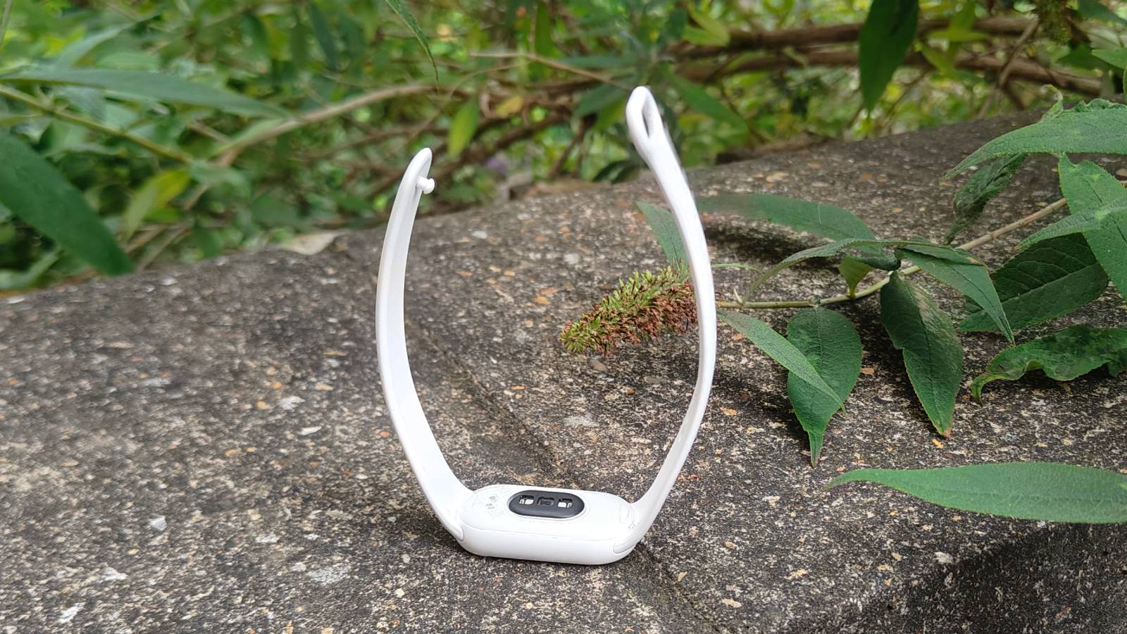 The Xiaomi Smart Band 10 upturned on a stone wall.