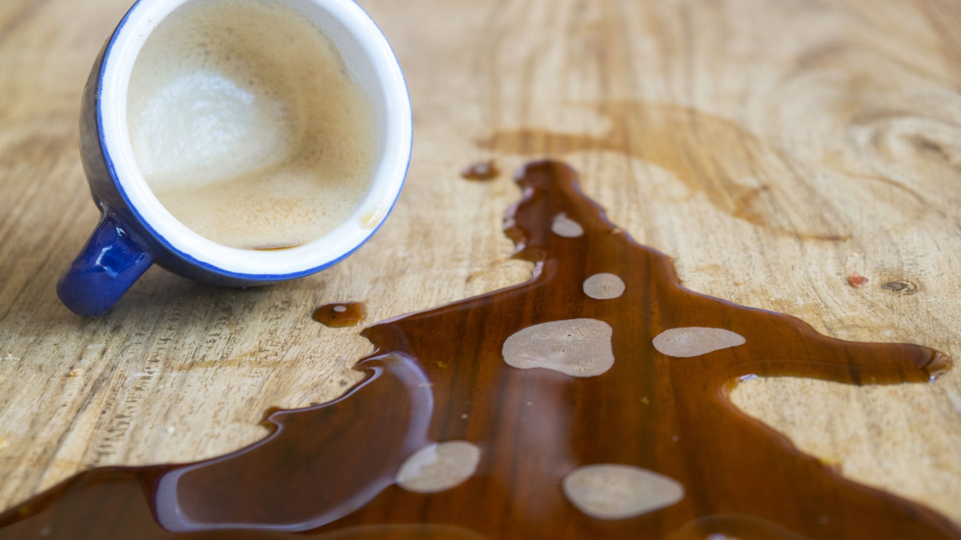 picture of espresso spilled on wooden table