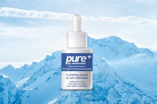 Pure+ serum displayed on backdrop of Swiss Alps