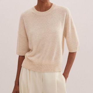 Image of woman wearing cashmere sleeveless sweater