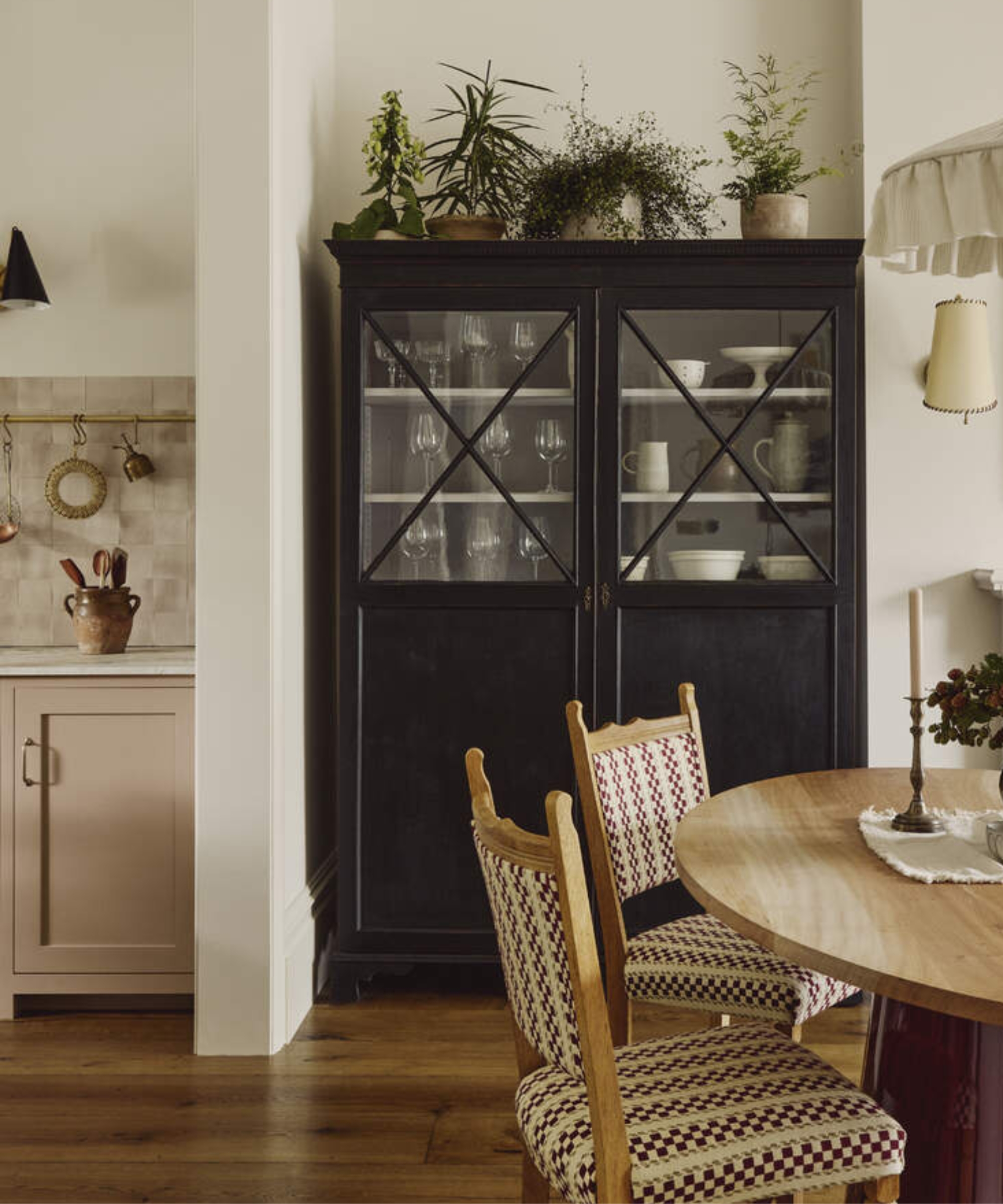 An open plan kitchen and dining space with a dark blue hutch in the corner