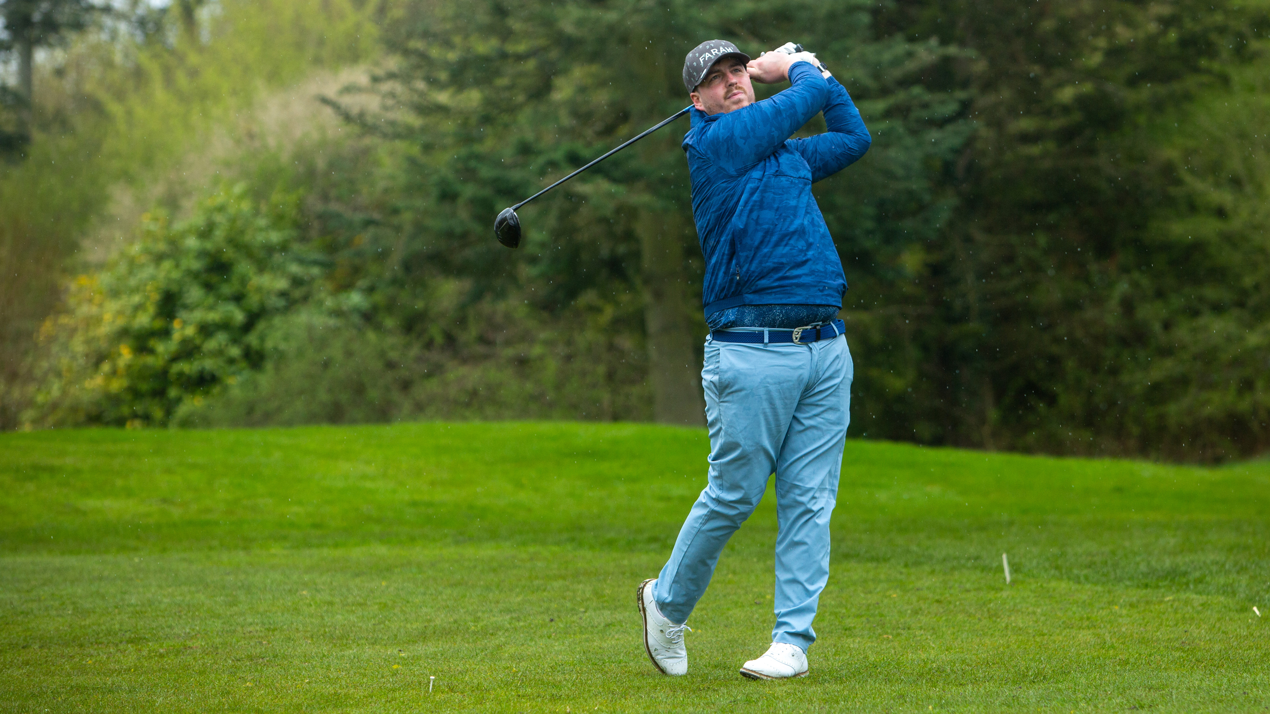 A golfer holds their finish on a drive