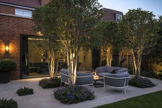 how to plan garden lighting: patio with tree lighting