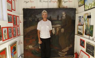 Artist Ilyas Farhutdinov, with his work