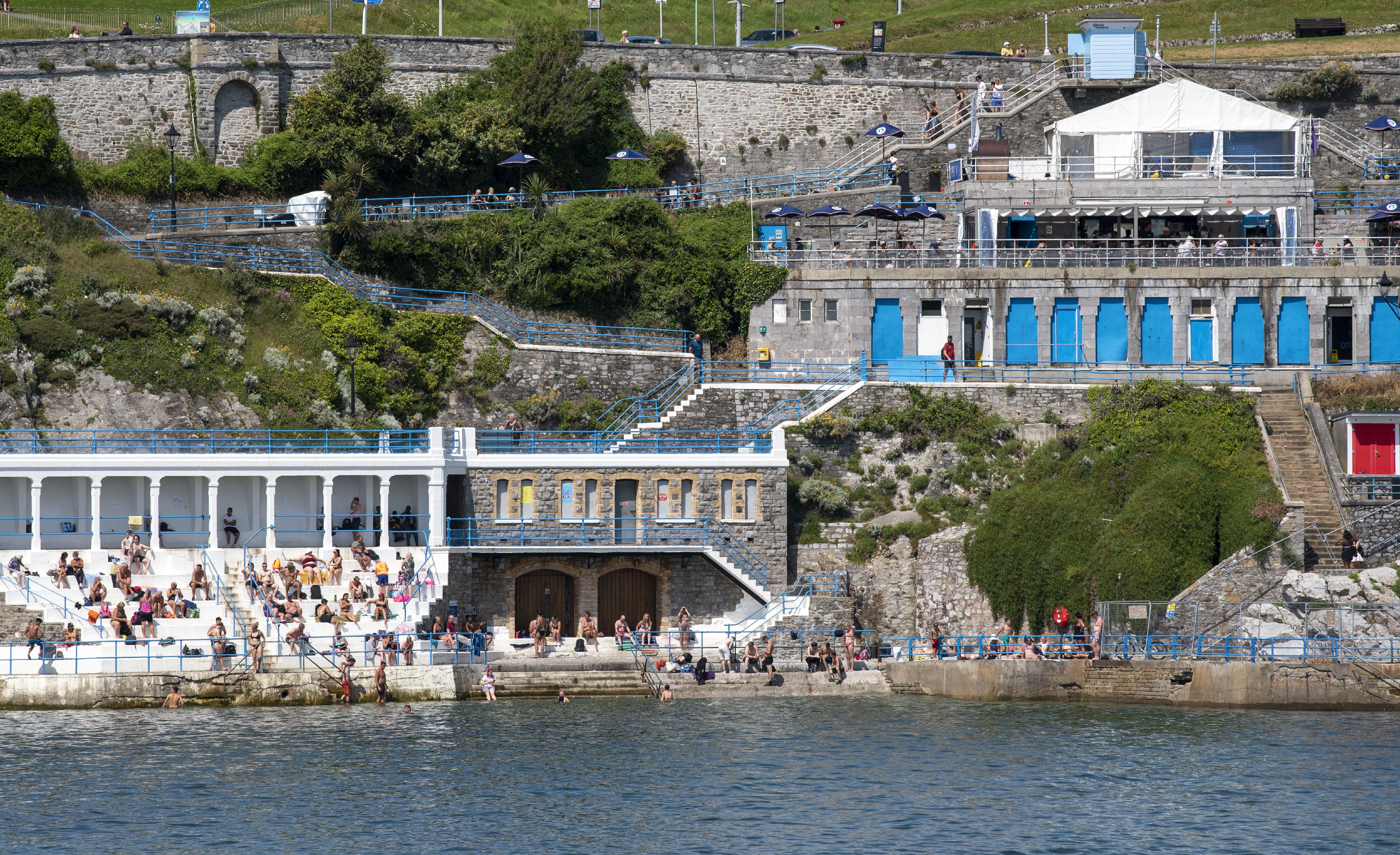 Blue and white bathing area overlooking the Cornish coast