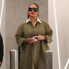 Rihanna wearing a green shirt dress and snakeskin boots