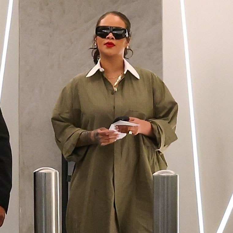 Rihanna wearing a green shirt dress and snakeskin boots