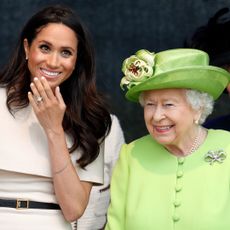 Meghan Markle wears a cream dress and attends a joint engagement with Queen Elizabeth, who wears a bright green coat, on June 14, 2018