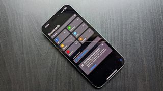 an image of an iPhone 16 Pro Max on a black table showing the Passwords app