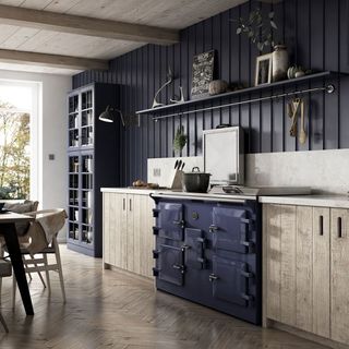 Kitchen and dining room with navy blue range cooker