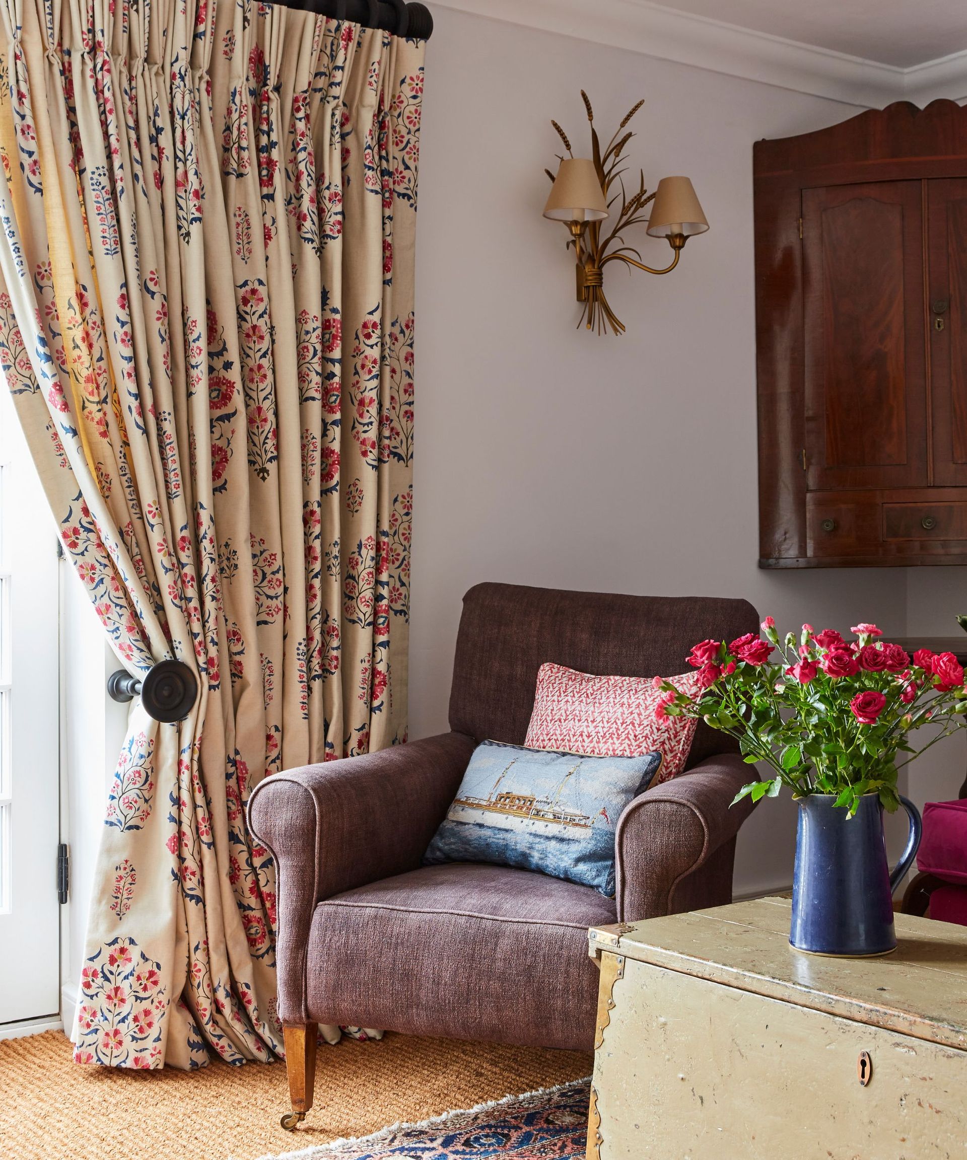 Brown armchair, wooden cabinet