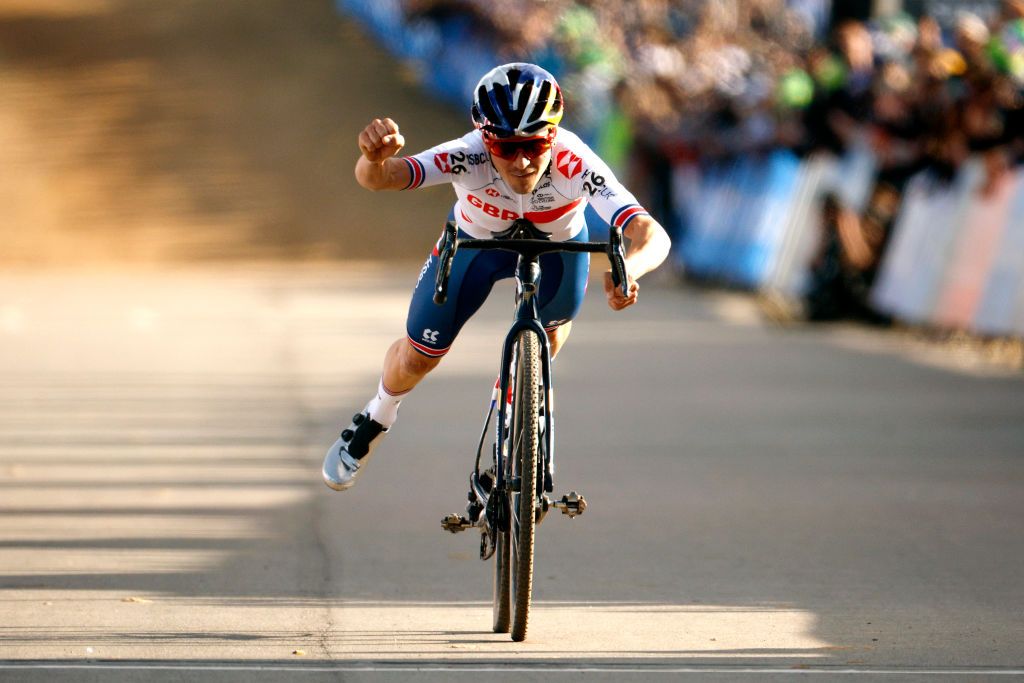 FAYETTEVILLE ARKANSAS JANUARY 30 Thomas Pidcock of The United Kingdom celebrates his victory by doing the superman pose during the 73rd UCI CycloCross World Championships Fayetteville 2022 Mens Elite Fayetteville2022 on January 30 2022 in Fayetteville Arkansas Photo by Chris GraythenGetty Images