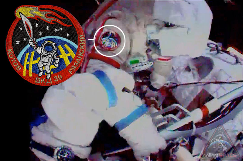 Cosomonaut Oleg Kotov can be seen wearing artist Luc van den Abeelen&#039;s Olympic torch patch while holding the real Sochi torch on a spacewalk outside the International Space Station, Nov. 9, 2013. 