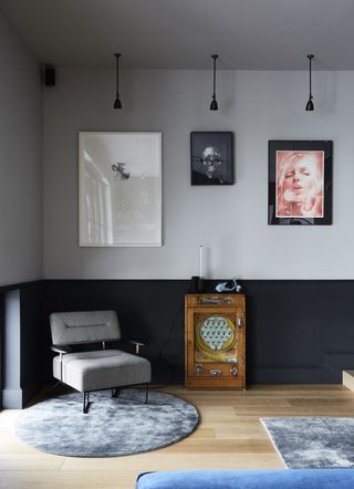 colors that go with black with a living room painted in two tones - the bottom with black and the section above with grey