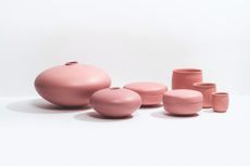Pink ceramic dishes photographed on a white surface against a white background