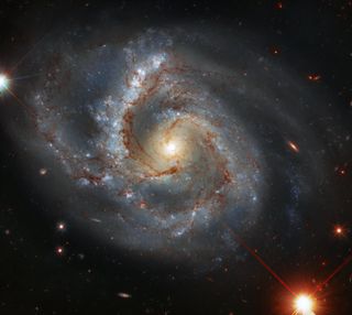 In this image, captured by the Hubble Space Telescope, you can see the brilliant spiral galaxy NGC 7678. The galaxy, which was discovered in 1784 by astronomer William Herschel, is located about 164 million light-years from Earth in the constellation Pegasus. Stretching about 115,000 light-years across, the galaxy is about the same size as the Milky Way galaxy.