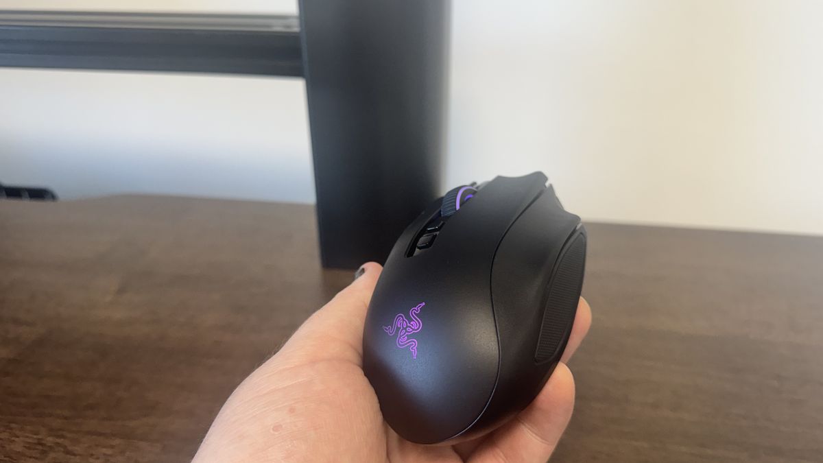 The Razer Naga V3 Pro in a hand, from the back right