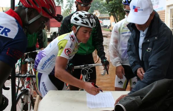 The riders sign on before the start.