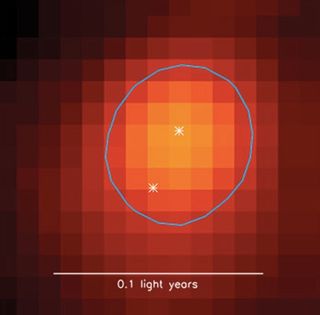 Radio image of a very young binary star system, less than about 1 million years old, that formed within a dense core (oval outline) in the Perseus molecular cloud.