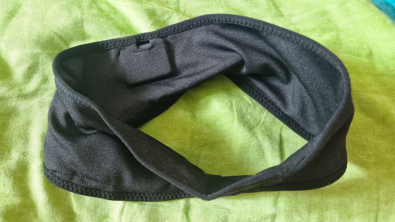 Musicozy Sleep Headphones laid out on a green pillow