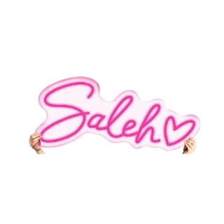 A pink neon sign that says 'Saleh'