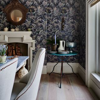 A dining room with wallpapered wall side table storage idea