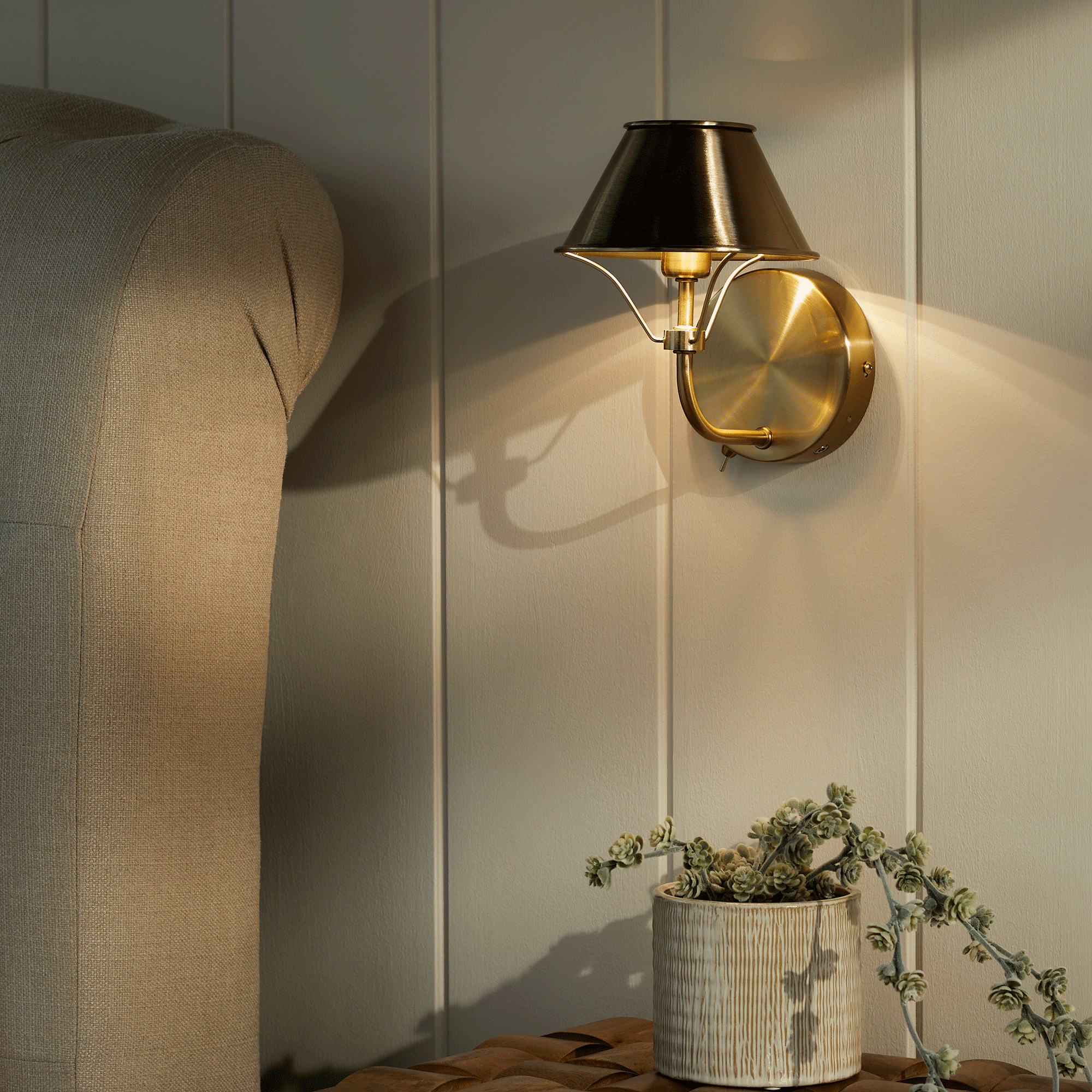 Next wall light on white panelled wall