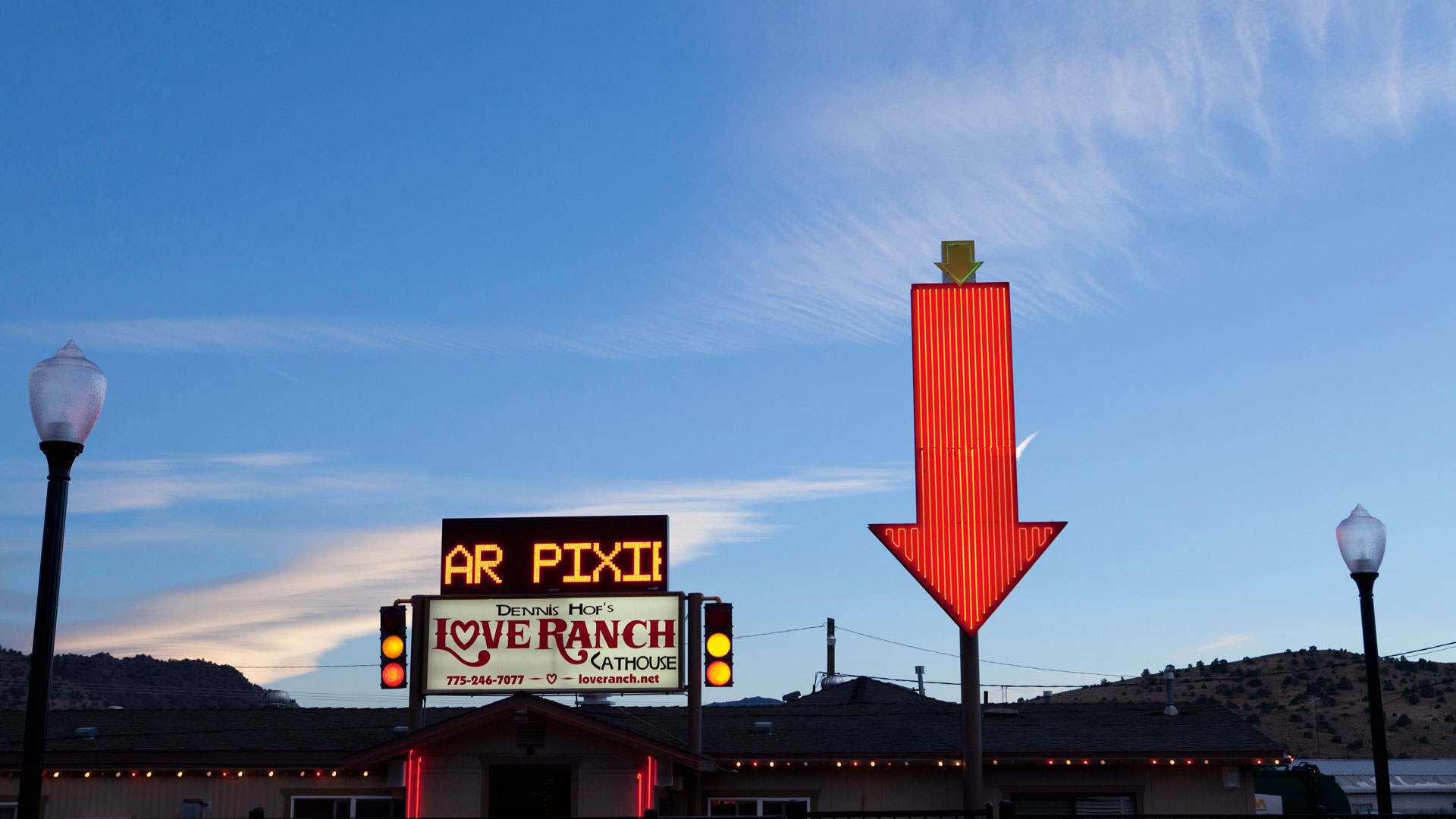 A neon sign points to the Love Ranch, a brothel located on the outskirts of Carson City