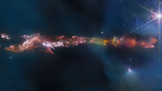 a colorful jet of gas in deep space stretches from left to right