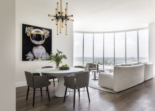 living room dining room combo with curved white sofa and circular dining table