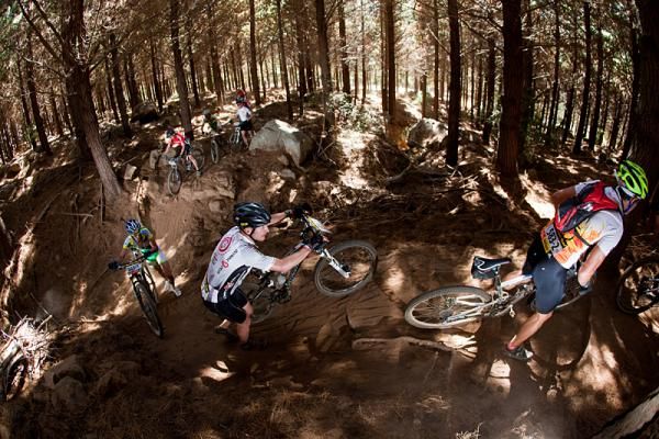 Riders climb through the forest