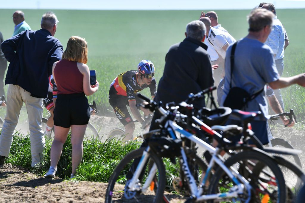 ROUBAIX FRANCE APRIL 17 Wout Van Aert of Belgium and Team Jumbo Visma competes passing through a cobblestones sector while fans cheer during the 119th ParisRoubaix 2022 Mens Elite a 2572km one day race from Compigne to Roubaix ParisRoubaix WorldTour on April 17 2022 in Roubaix France Photo by Luc ClaessenGetty Images